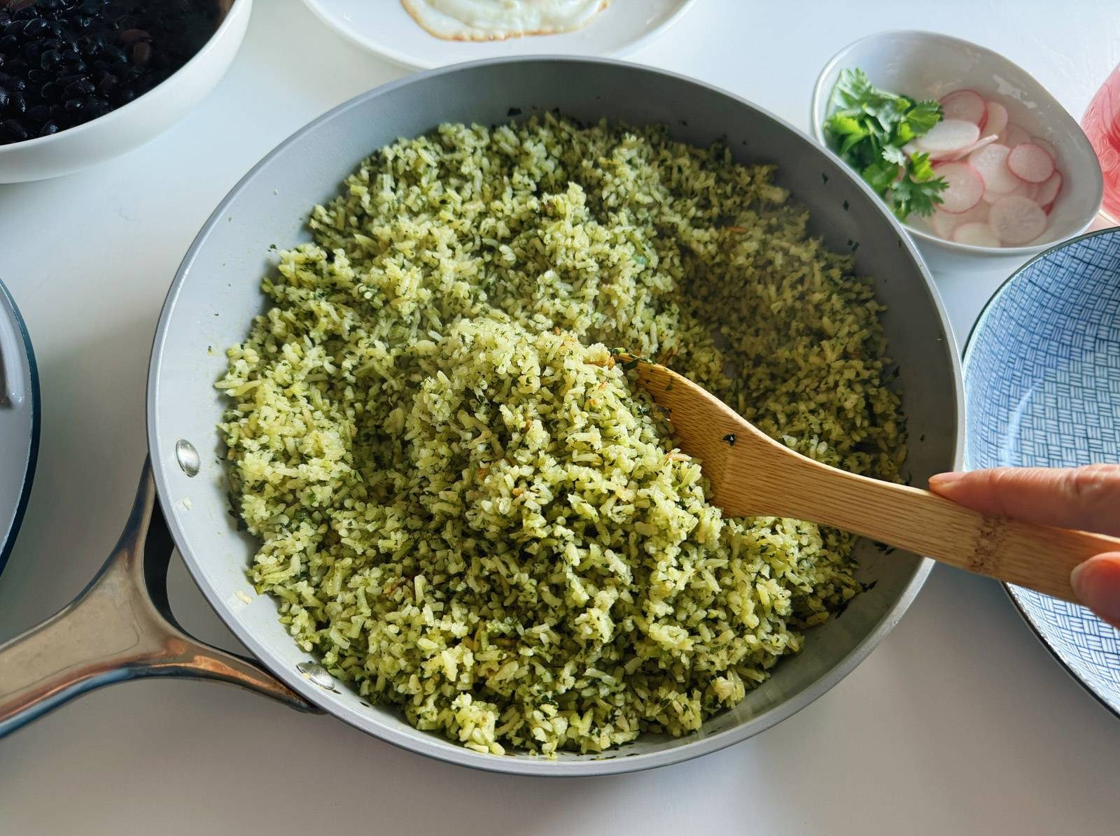 Cooked green rice in a pan.