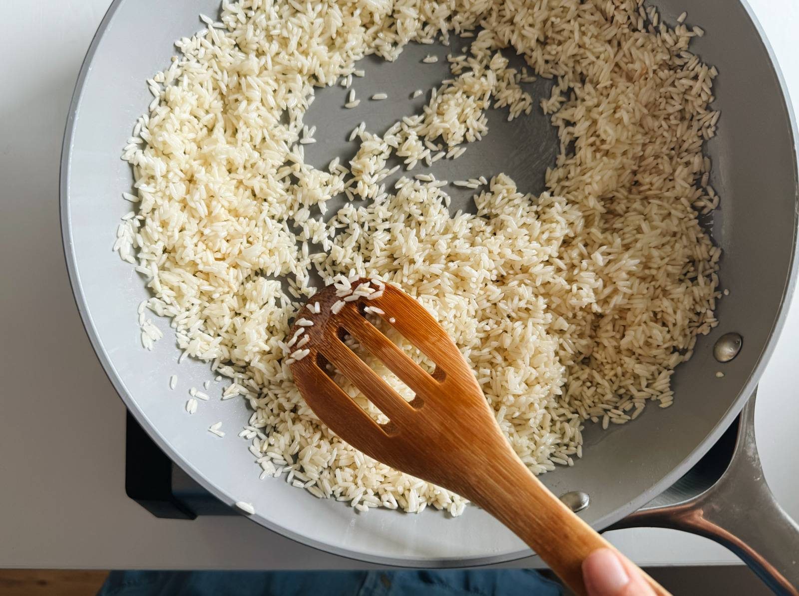 Toasting rice in a pan.
