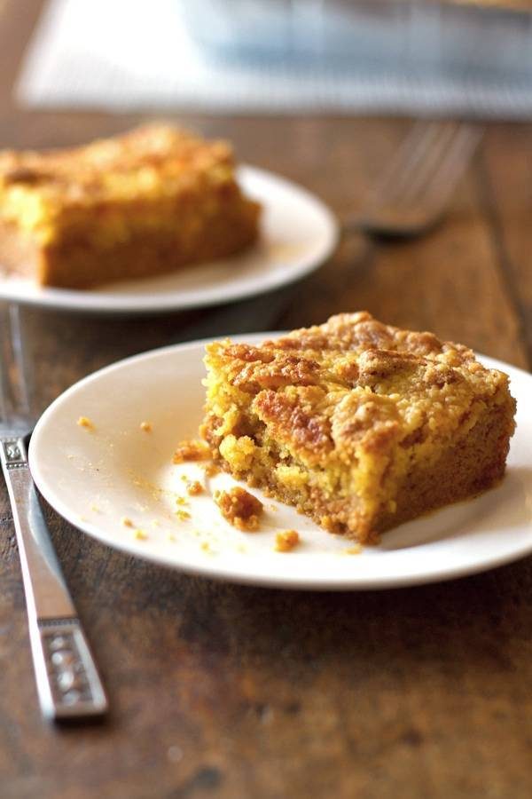 Two pumpkin dessert bars on white plates.
