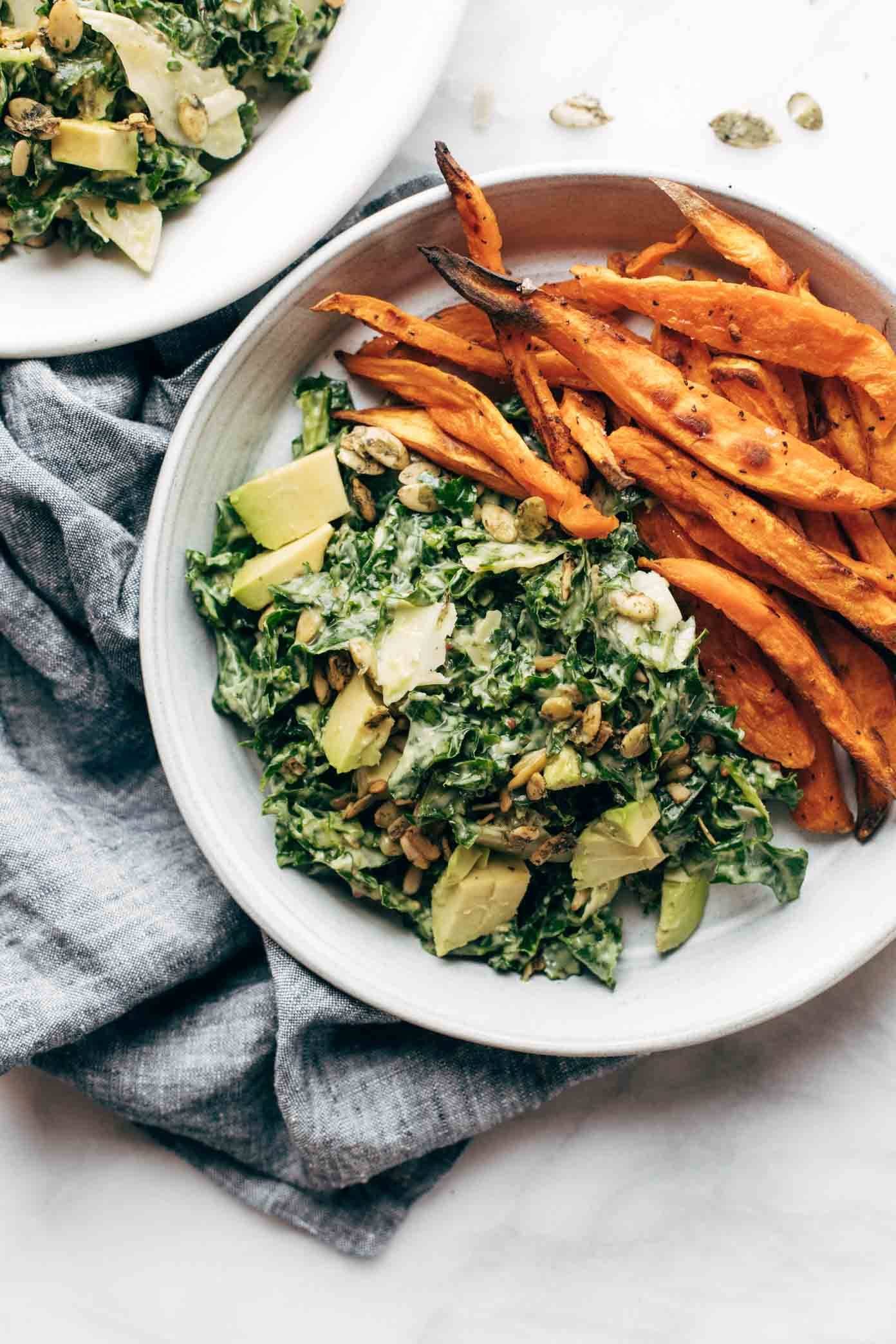 Avocado kale caesar salad with sweet potato fries.