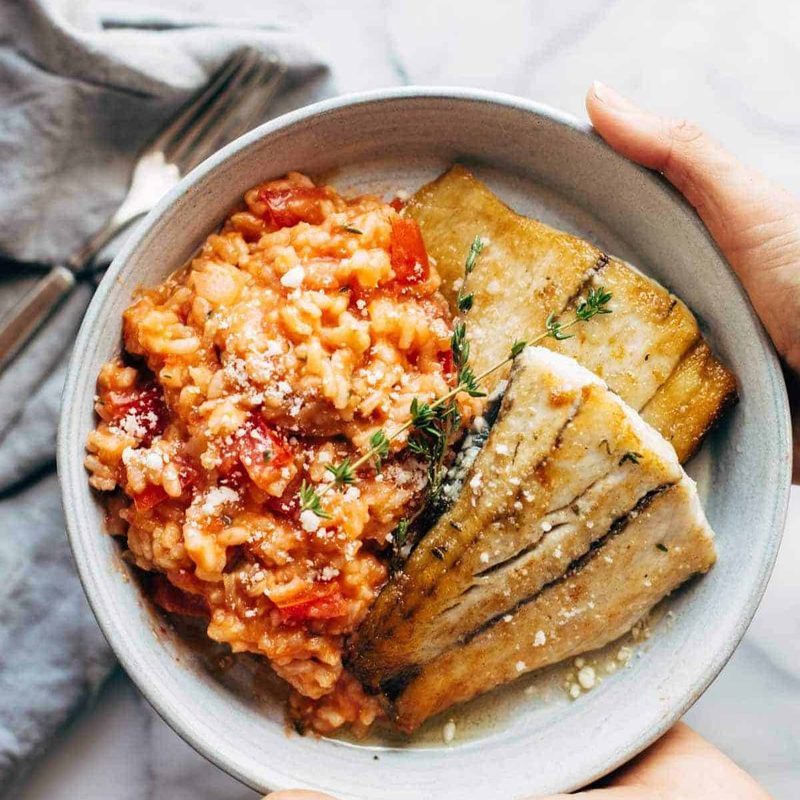 A picture of Creamy Tomato Risotto with Pan Fried Barramundi