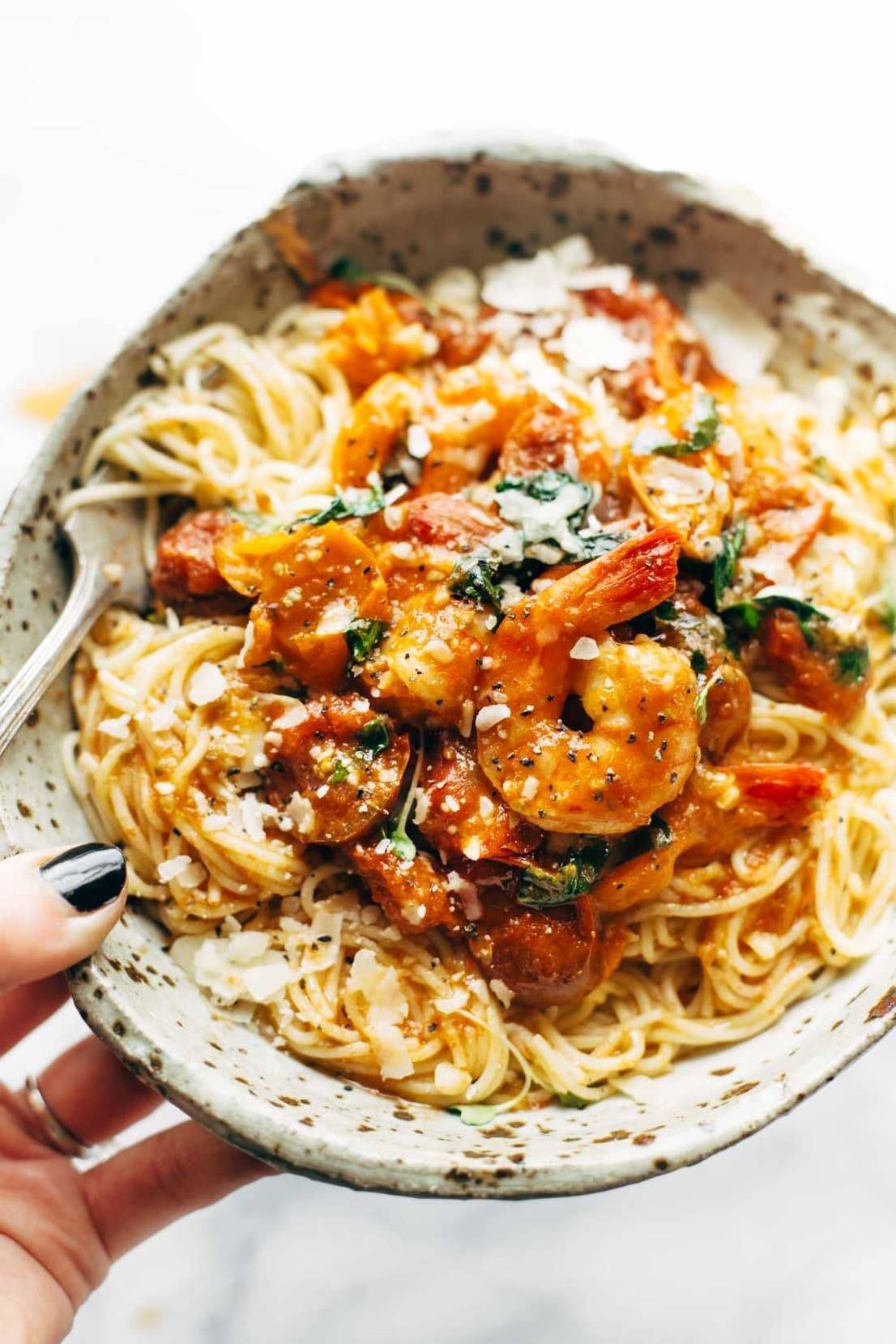 A bowl full of Garlic Butter Capellini Pomodoro with Shrimp.