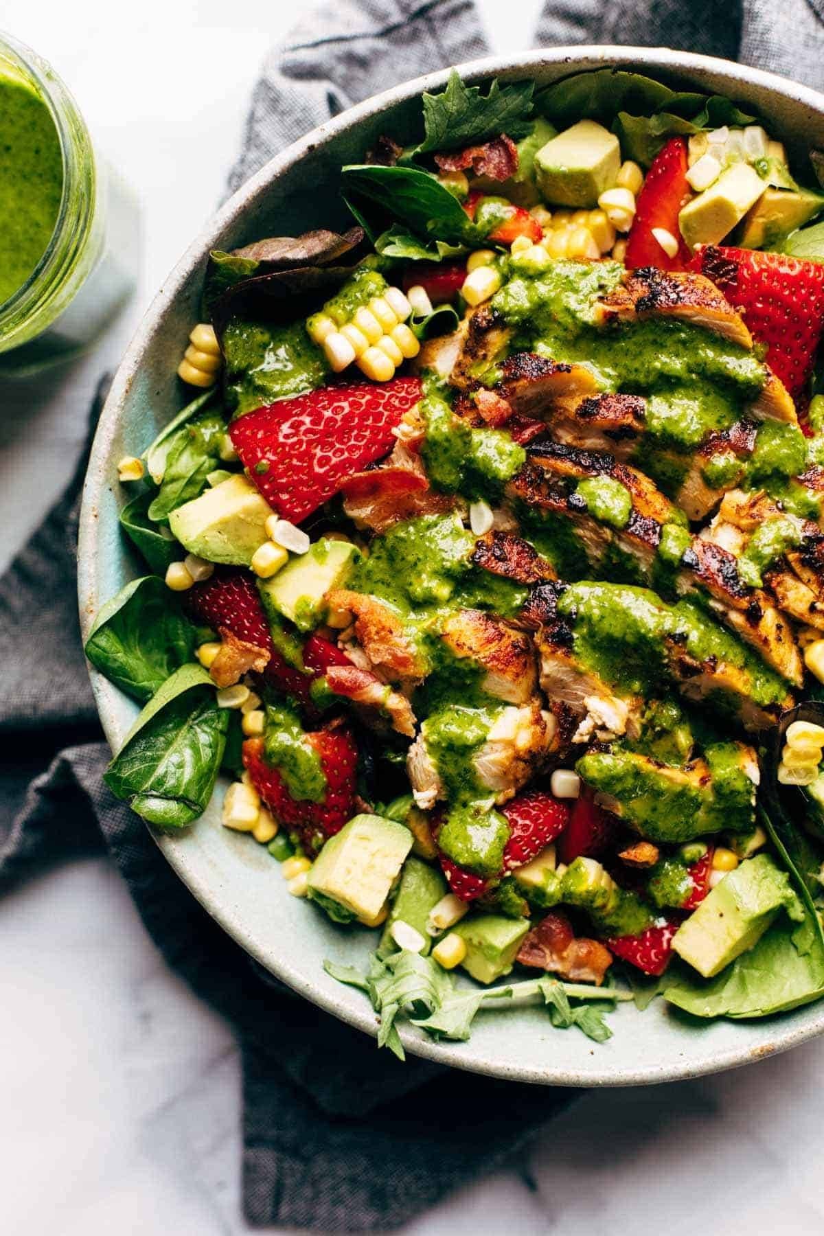 Salad with grilled chicken, strawberries, corn, and cilantro vinaigrette.