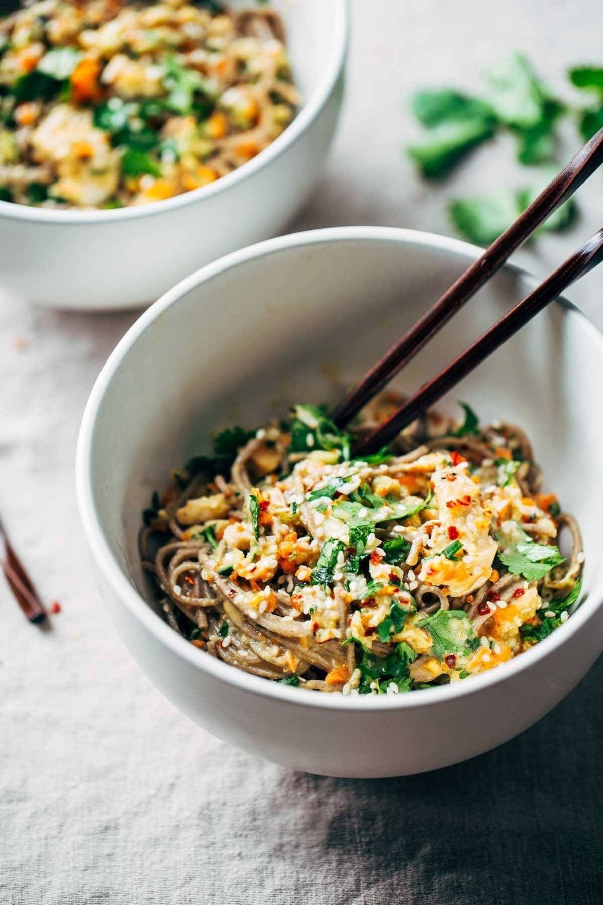Chopped Chicken Sesame Noodle Bowls with chopsticks.