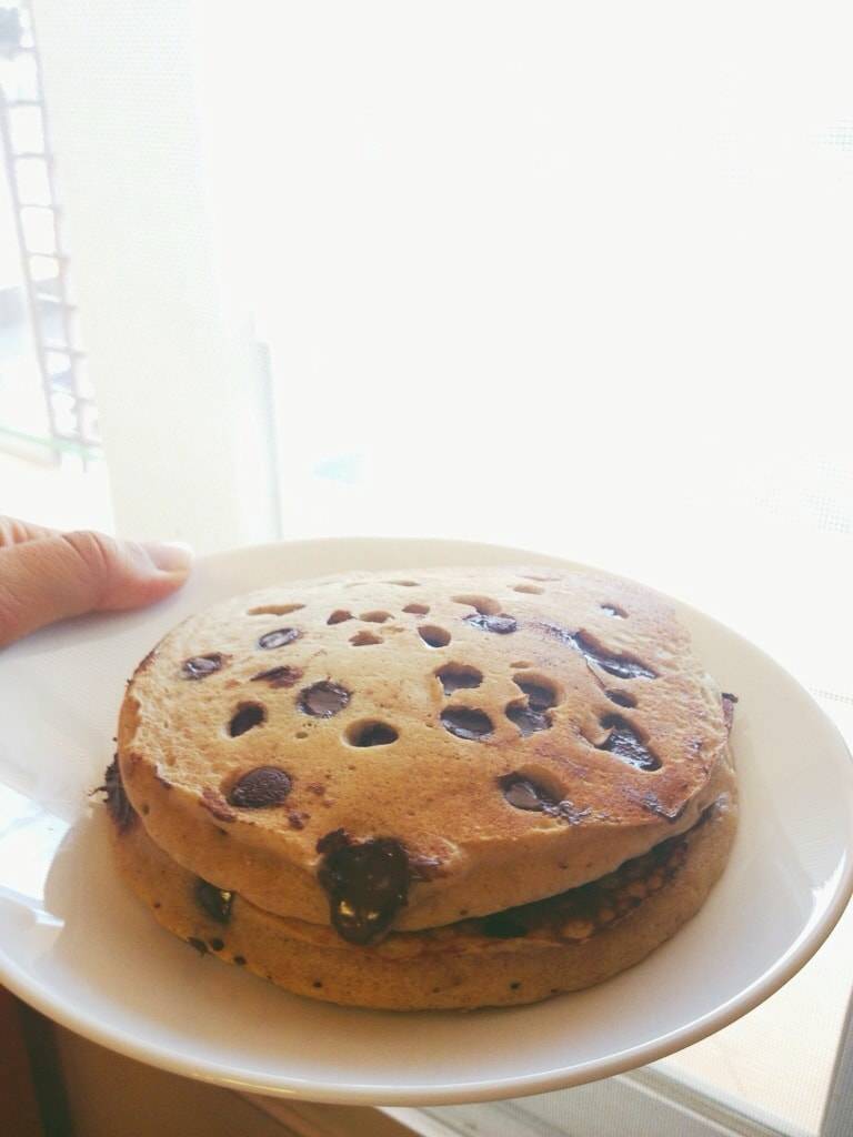 Whole wheat pancakes stacked on a plate.