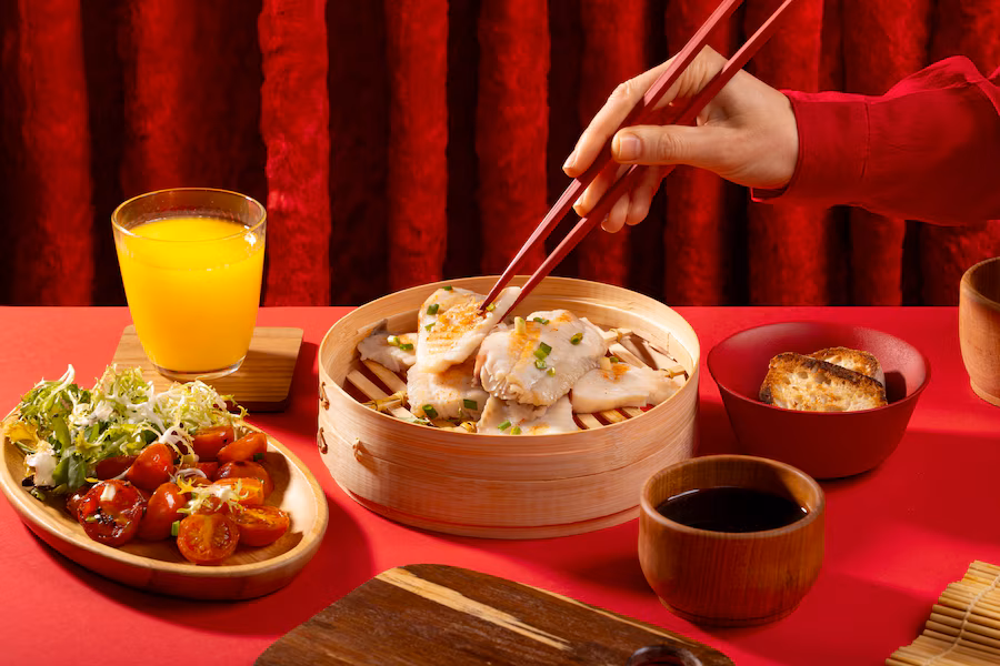 A person using chopsticks to pick the food