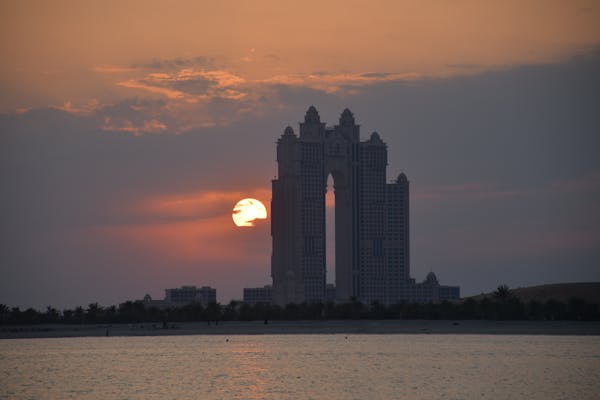 Atwin tower building against sunset