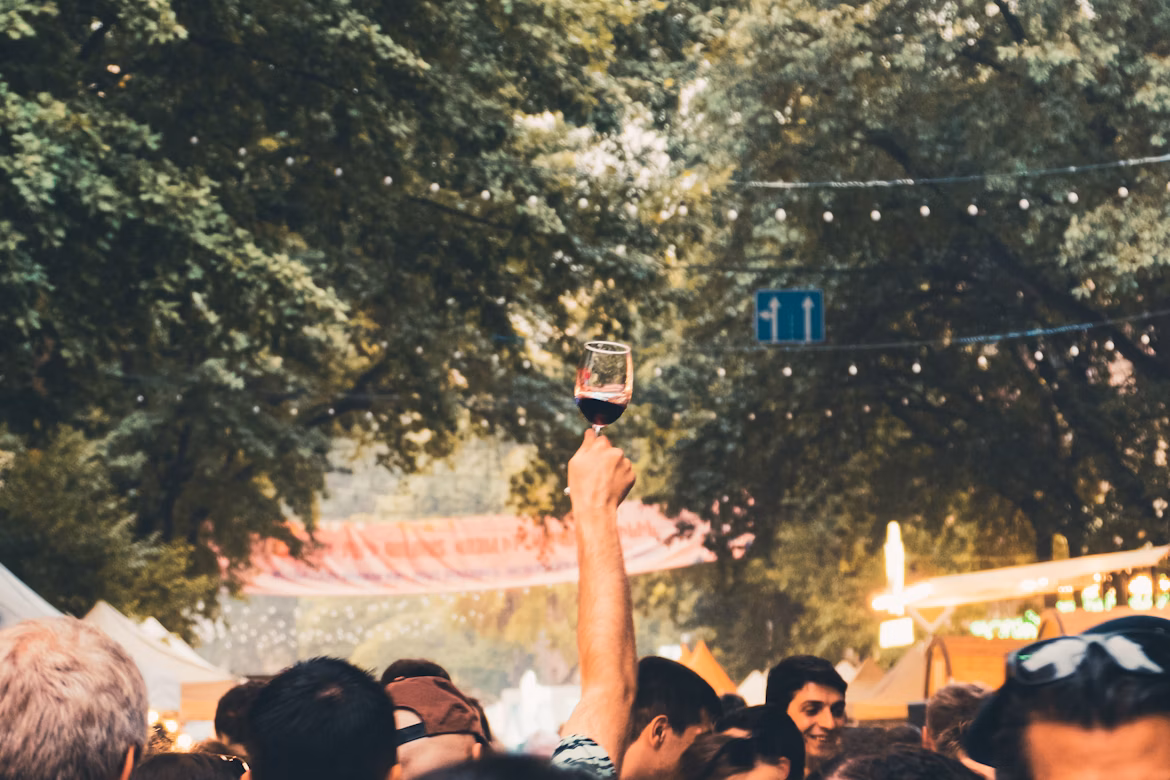 Visitors enjoying wine under twinkling lights at the Rheingau Wine Festival