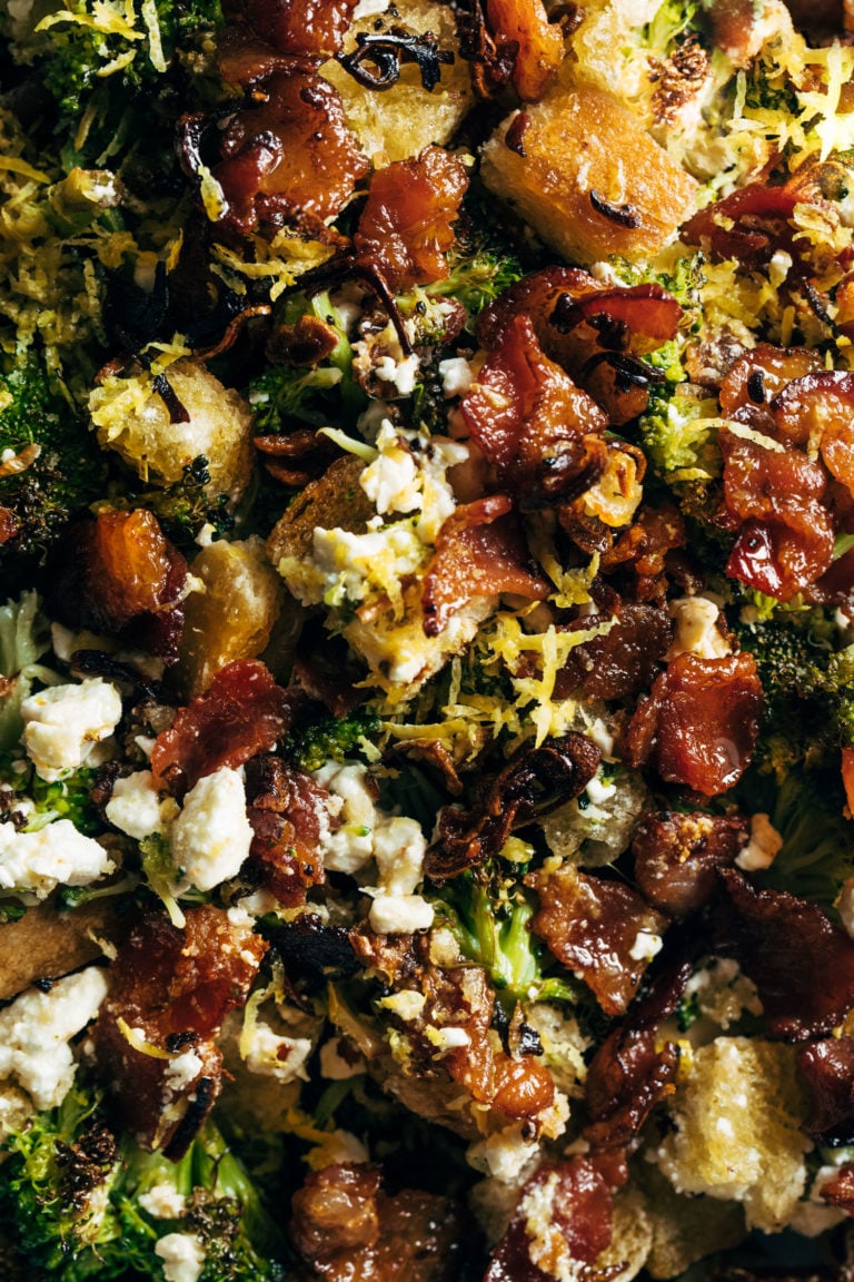 A broccoli salad with with bacon and croutons in it.