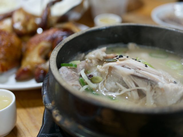 A comforting bowl of chicken soup, with tender pieces of chicken, vegetables, and flavorful broth, perfect for a cozy meal