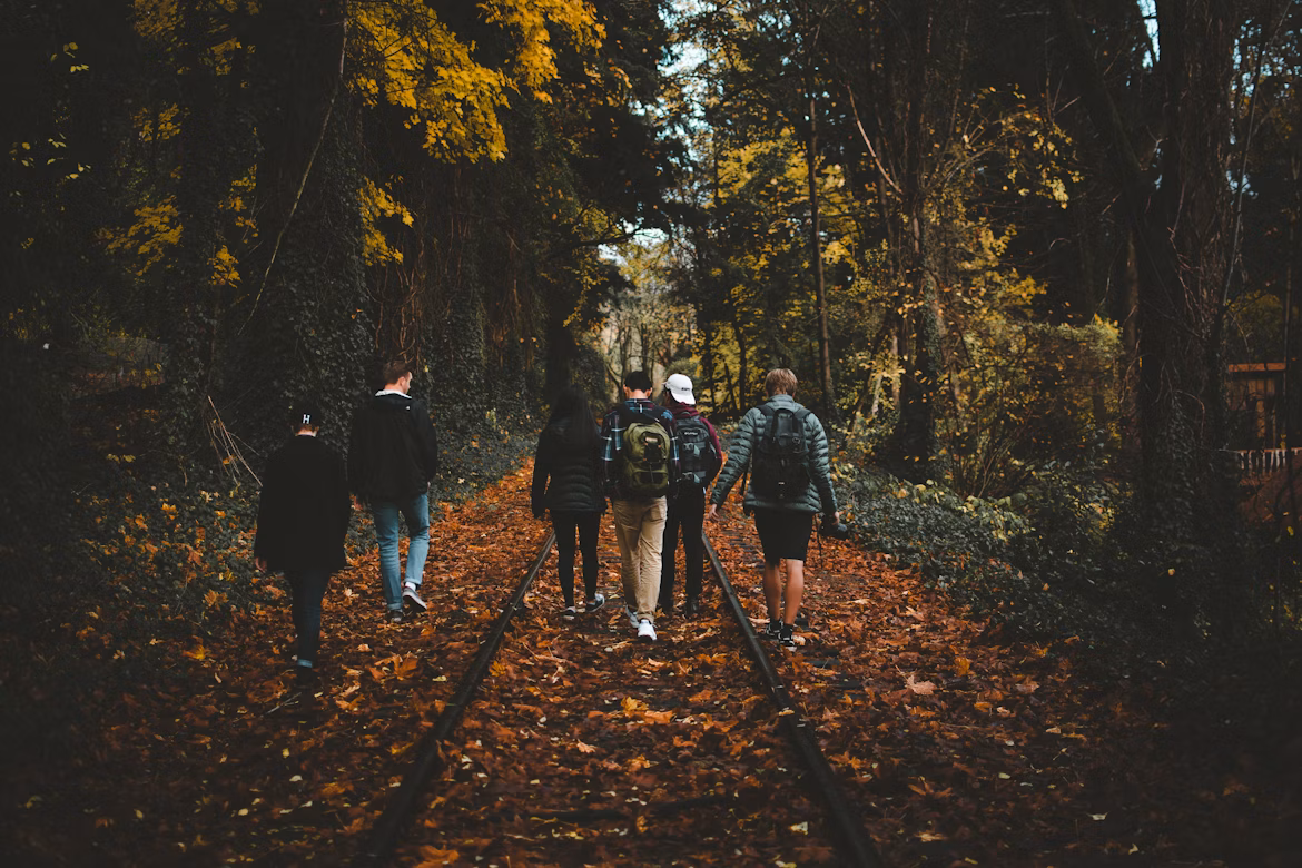Travelers in autumn jackets in Borjomi park