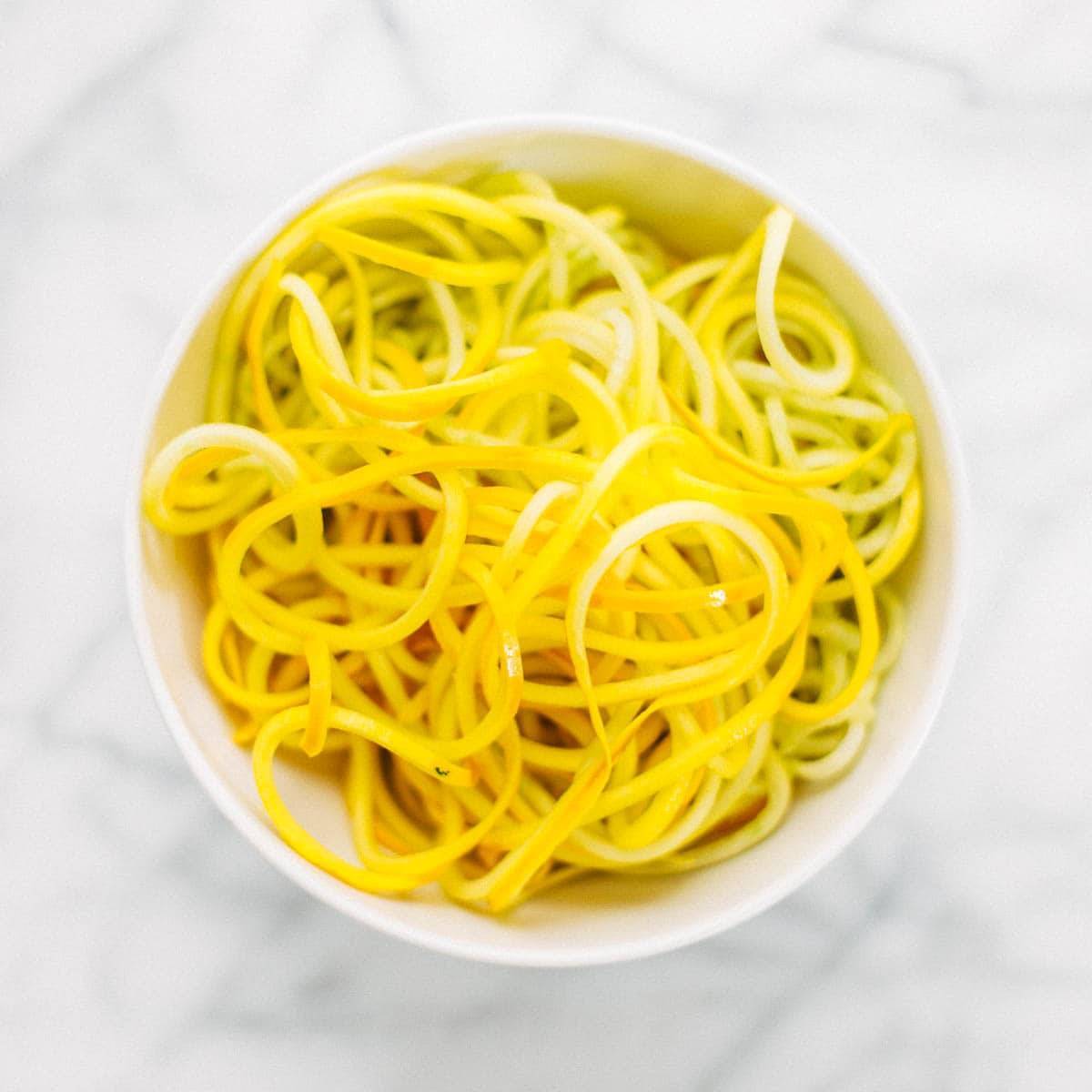 A spiraled zucchini in a bowl.
